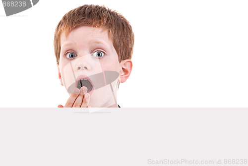Image of cute  boy surprised with white board