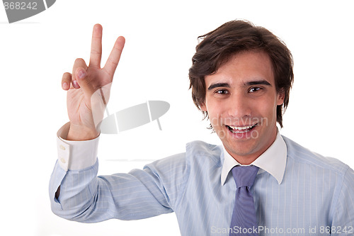 Image of Young bussiness man with arm raised in victory sign