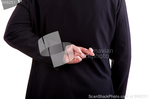 Image of business man seen from behind, his hands back, her fingers crossed