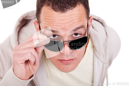 Image of portrait of a young adult man looking over his sunglasses