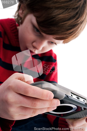 Image of Young boy playing handheld game console