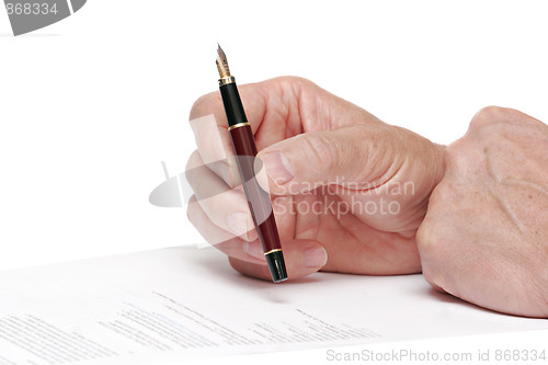 Image of reading a document  with a fountain pen