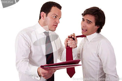 Image of two businessmen discussing because of work, pointing to a document and pull the tie