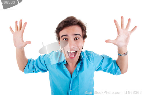 Image of Portrait of a very happy young man with his arms raised, and hands open