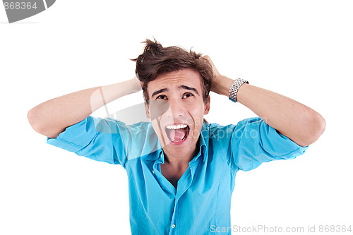 Image of Strongly afflicted young man, screaming and pulling hair