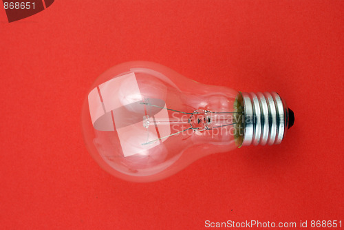 Image of lightbulb isolated on red