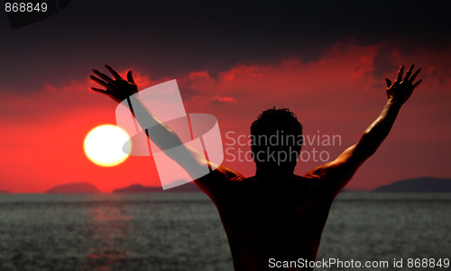 Image of Man standing looking at ocean