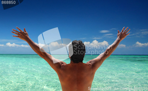 Image of Man standing looking at ocean