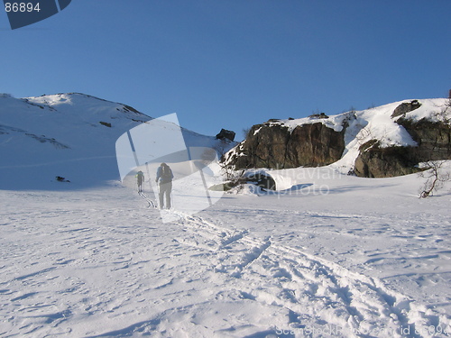 Image of Two men skiing in mountains