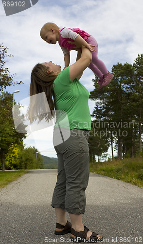 Image of Obese mother lifting child