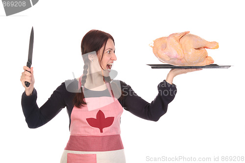 Image of mad housewife with knife and chicken 