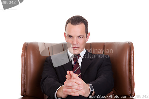 Image of Businessman seated on a chair, isolated on white background. Studio shot.
