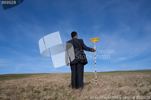 Image of businessman cleaning the environment