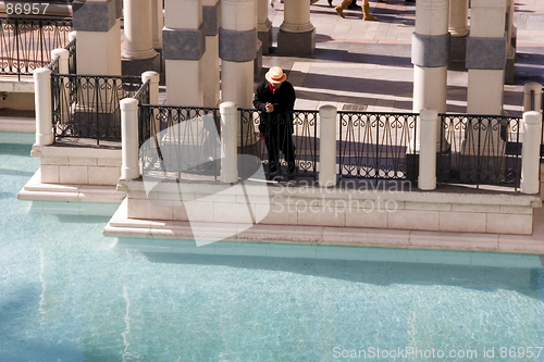 Image of Gondolier Looking At the Water by the Dock