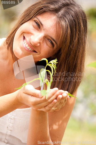 Image of woman holding a plant