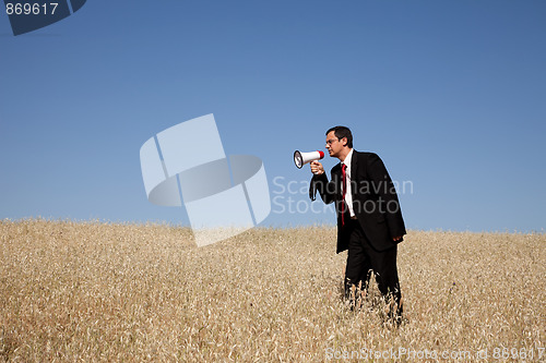 Image of Businessman shouting at the megaphone to you