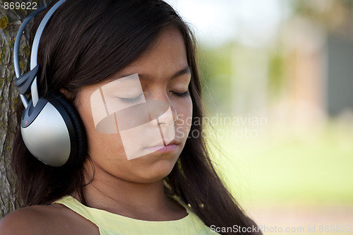 Image of young child listening music