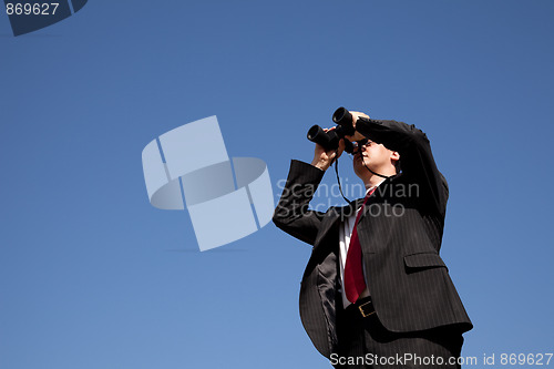 Image of Businessman looking through binoculars