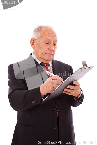 Image of senior businessman writing