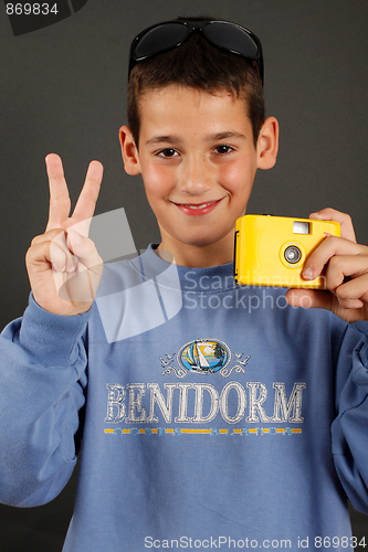 Image of A young boy with a disposable camera
