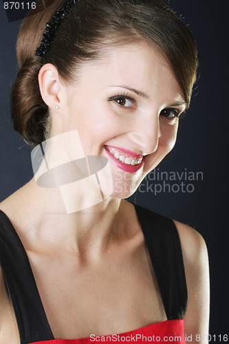 Image of Toothy smiling brunette in red