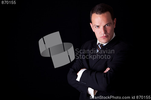 Image of Portrait of a  business man isolated on black background. Studio shot.