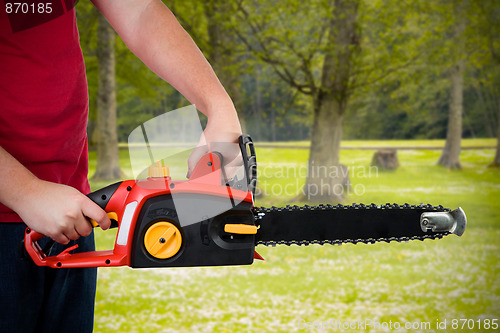 Image of Man Holding Chainsaw 