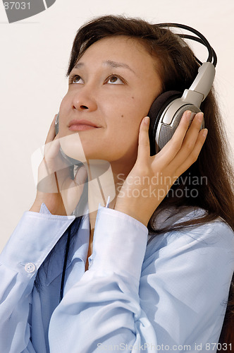 Image of Girl in a blue shirt with headphones