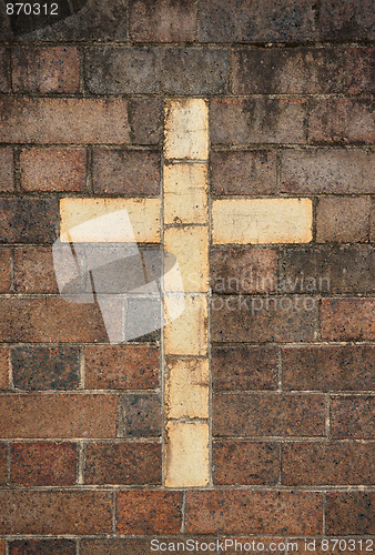 Image of christian cross in brick wall