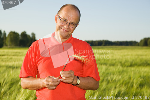 Image of Middle-aged man smiling on a field