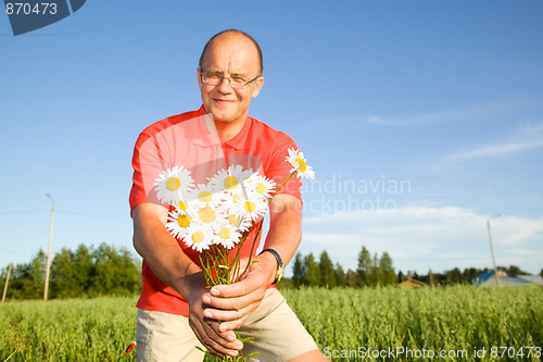 Image of Middle-aged man giving flowers