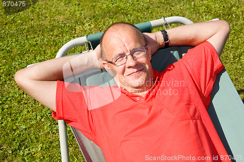 Image of Happy man lying on hammock