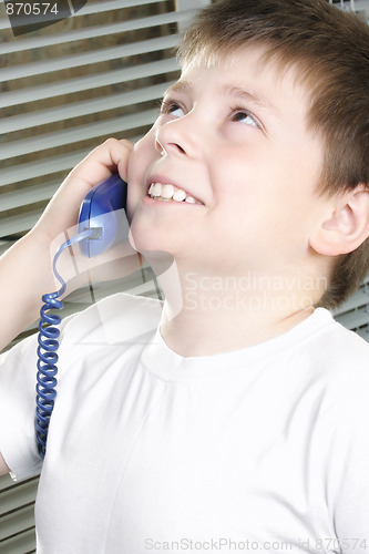 Image of Smiling boy in white on phone