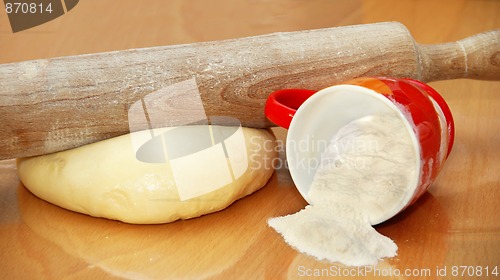 Image of Rolling pin over dough