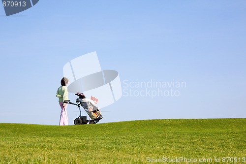 Image of Golfer and caddy