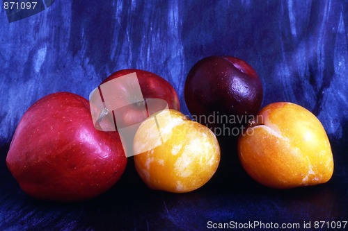 Image of Apples and plums isolated on painted background