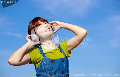 Image of Happy woman listen music