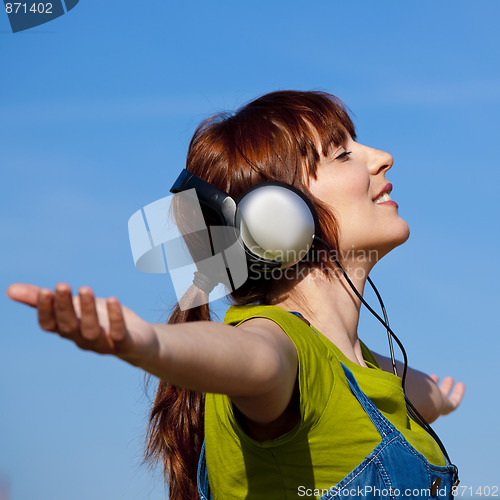 Image of Happy woman listen music