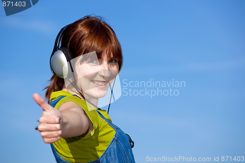 Image of Happy woman listen music