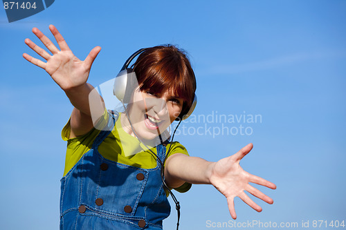 Image of Happy woman listen music