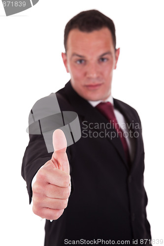Image of Young businessman with thumb raised as a sign of success