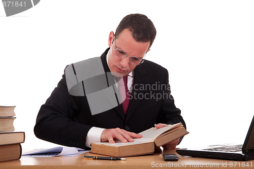 Image of man on desk reading and studying