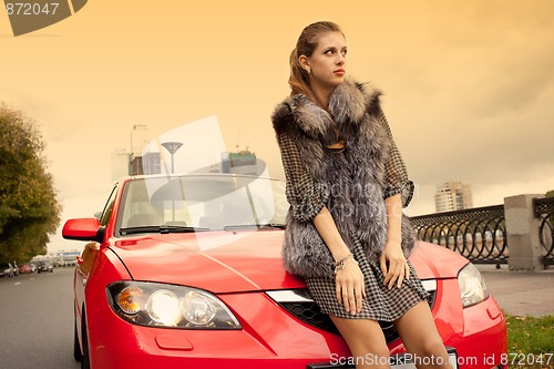 Image of girl and a red car