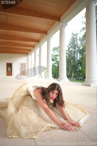 Image of bride in golden gown on floor