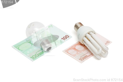 Image of Energy save lamp versus bulb on euro bills isolated