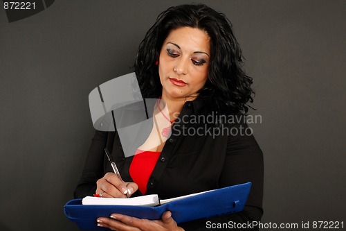 Image of Woman writing on a binder