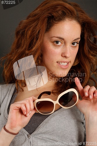 Image of Girl trying on sunglasses