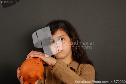 Image of Young girl and is piggy bank