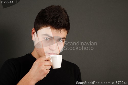 Image of Young guy drinking coffee