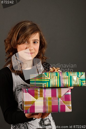Image of Girl holding some gifts and smiling
